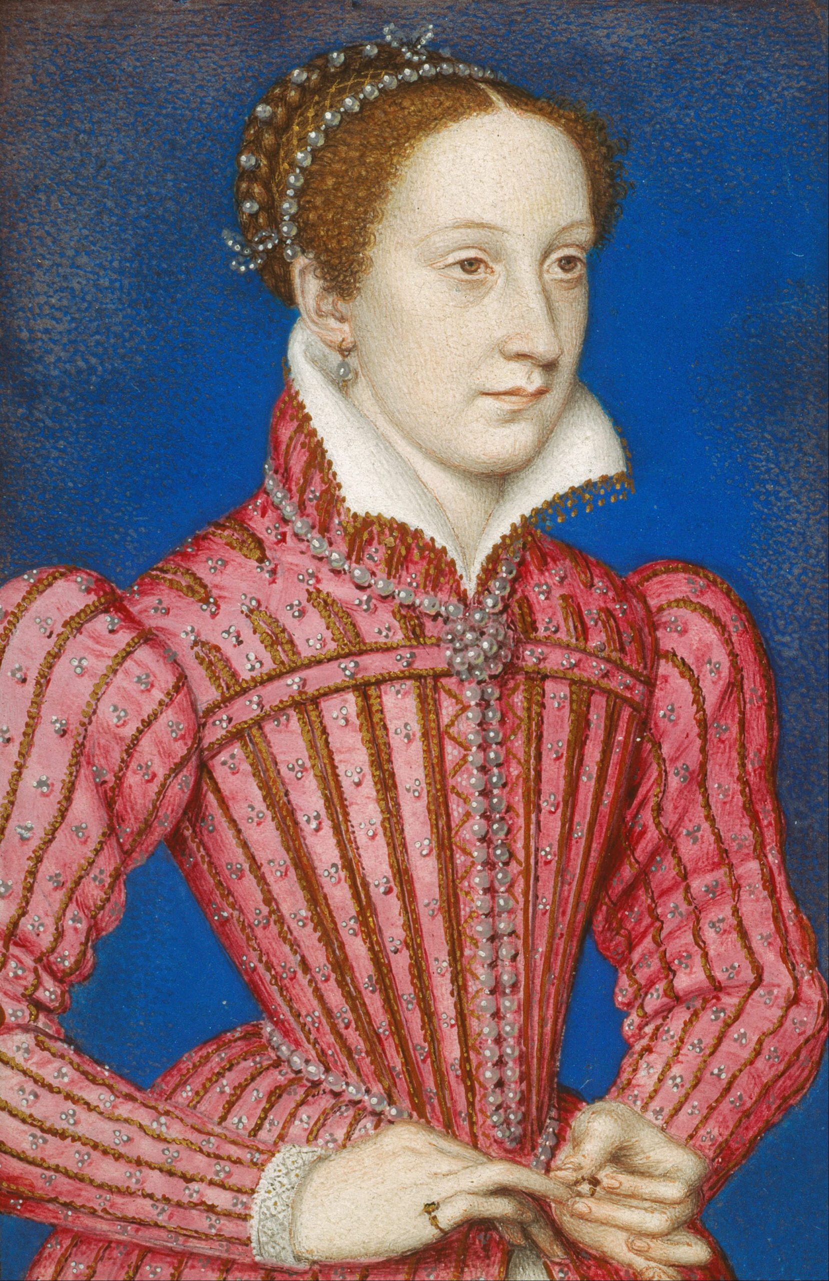 A woman with pale skin and brown hair in a pink, pearl-embellished Renaissance dress with a high white collar, standing against a blue background. She has a calm expression and holds her hands together at her waist.