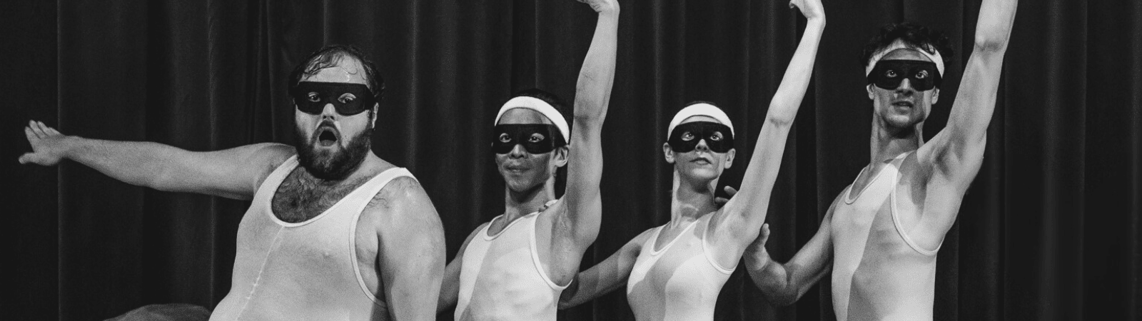 Four people in matching tank tops, headbands, and eye masks pose theatrically in front of a curtain, with arms raised and expressive faces.