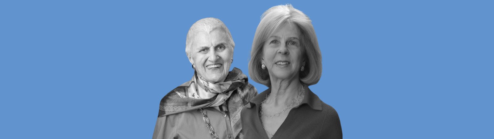 Two older women stand side by side, smiling. One wears a scarf and a necklace; the other has a bob hairstyle and pearl earrings. The background is solid blue.