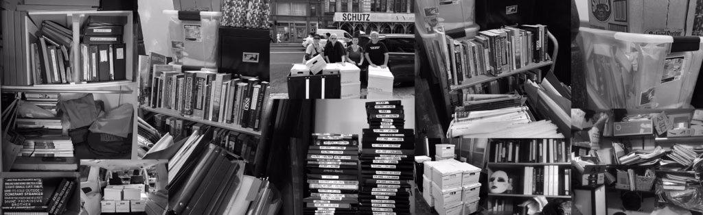 A black-and-white collage of cluttered bookshelves, labeled storage boxes, files, papers, and a central image of people moving boxes, depicting an organized but crowded archival or storage area.