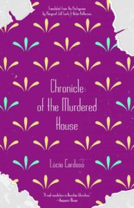 Book cover with a purple background, yellow and blue decorative patterns, and torn edges revealing light blue underneath. The title reads “Chronicle of the Murdered House” by Lúcio Cardoso.
